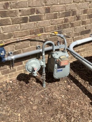a bench in front of a brick wall