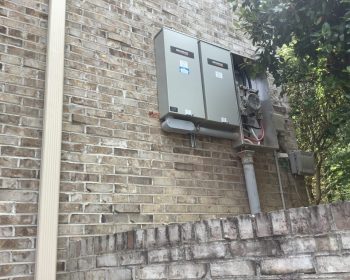 a person standing in front of a brick building