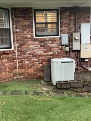 a large lawn in front of a brick building